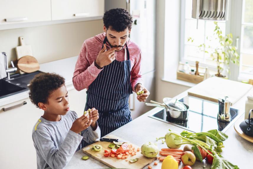 A father and son preparing a meal together