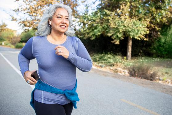 An older lady jogging down the road