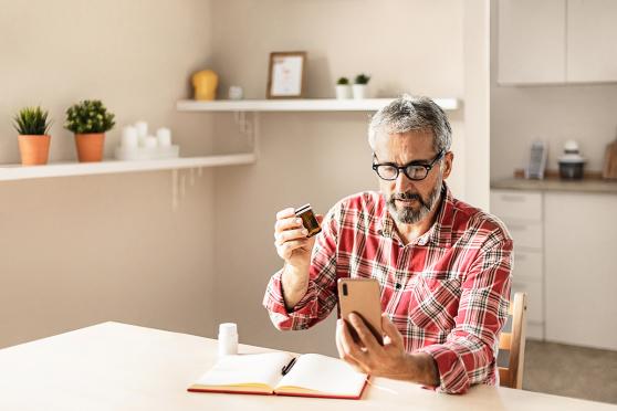 A man sitting at a table doing an at-home health screening