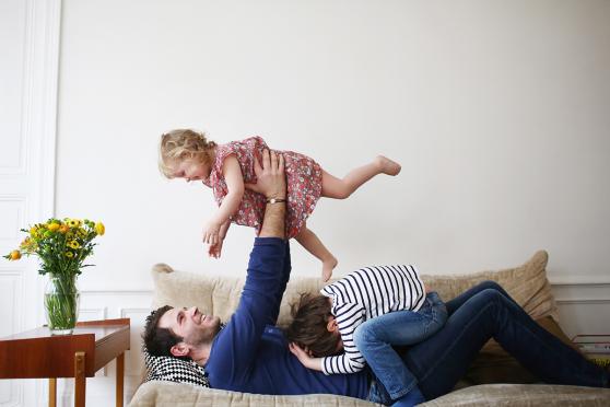 A dad playing with his children