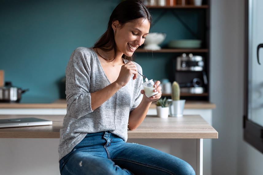 Woman eating food that contains probiotics for an article on gut and mental health