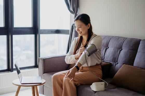 Woman measuring her own blood pressure