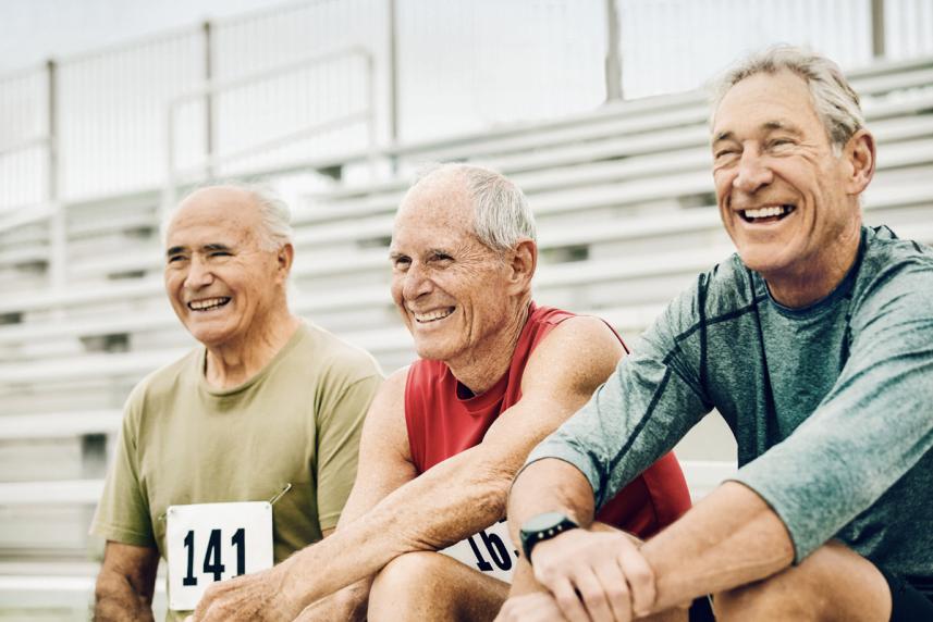 Three older men preparing for a foot race.