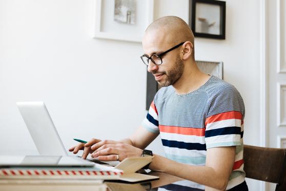 Man typing on a laptop for an article about HSAs