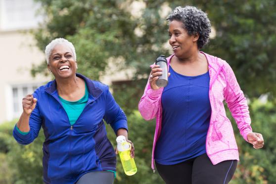 Two older women jogging outside