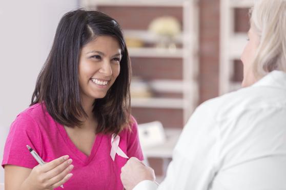 A nurse discussing breast cancer with a patient