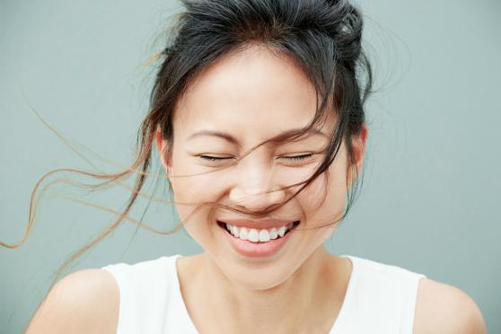 A smiling woman with healthy hair and skin