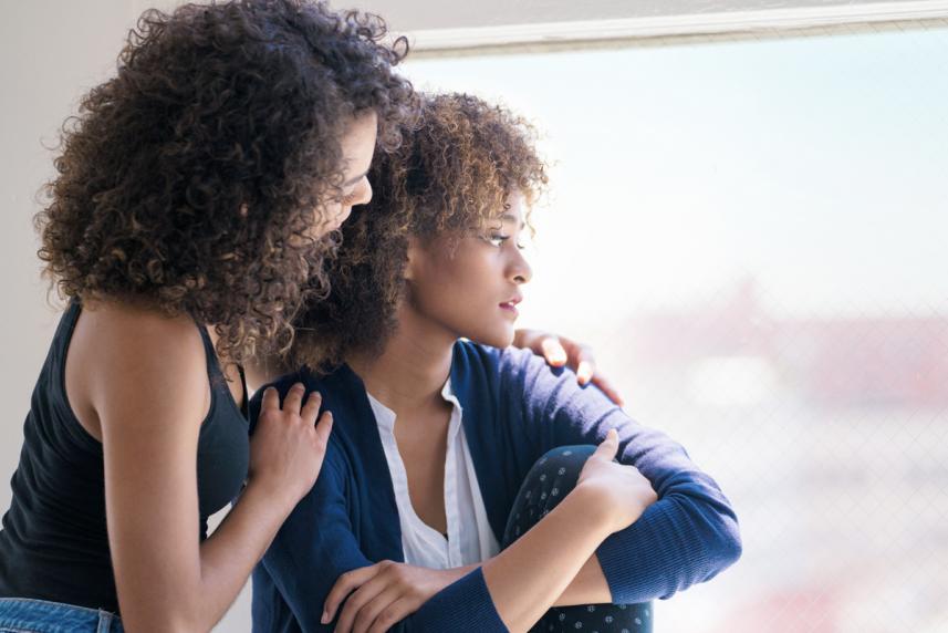 Woman comforting a friend who may be being abused