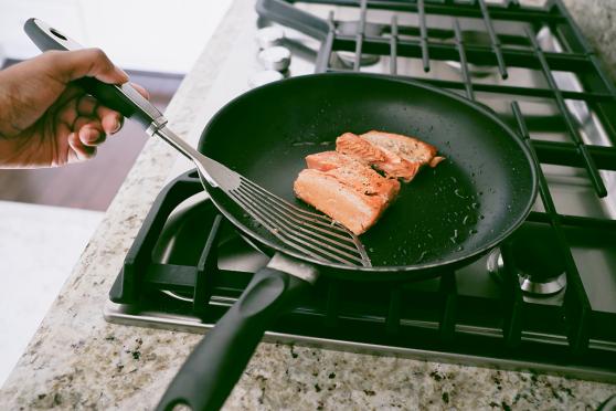 Person cooking fish