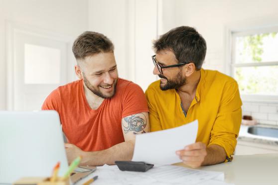 Two men researching health insurance options together