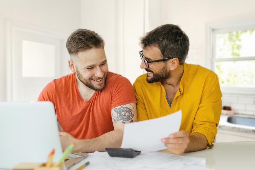 Two men researching health insurance options together