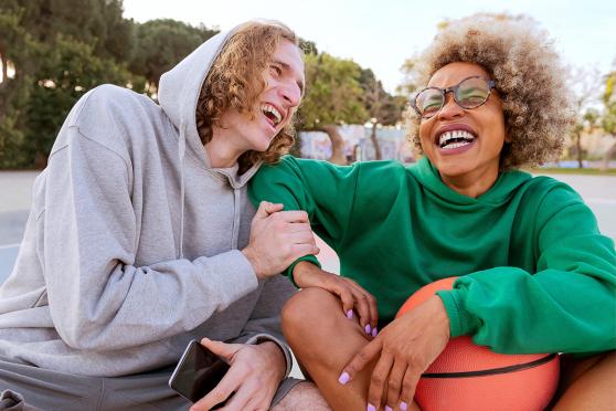 Two young adults laughing together