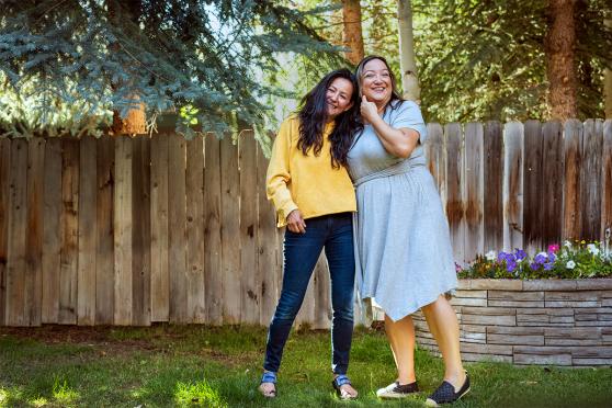 Two women hugging each other outside