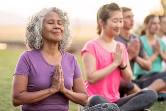 A group of women meditating outside