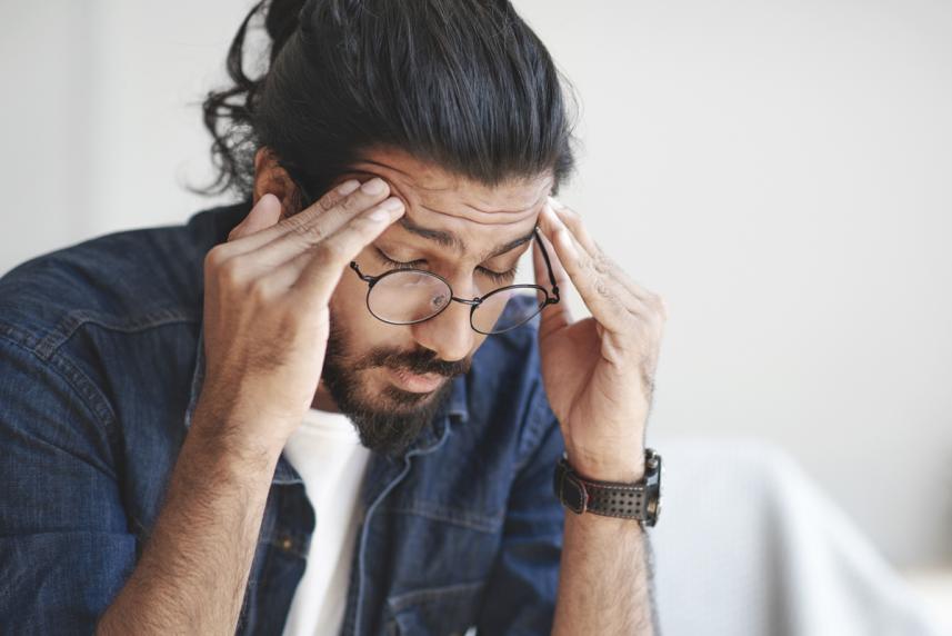 A man trying to ease his headache